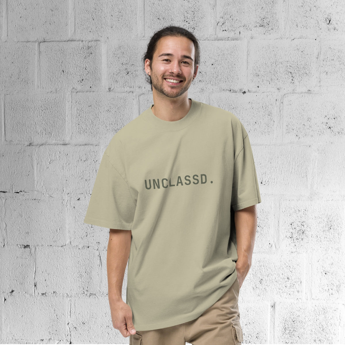 Male Model wearing the UNCLASSD CORE Oversized Tee in faded green, boxy streetwear fit designed for movement.
