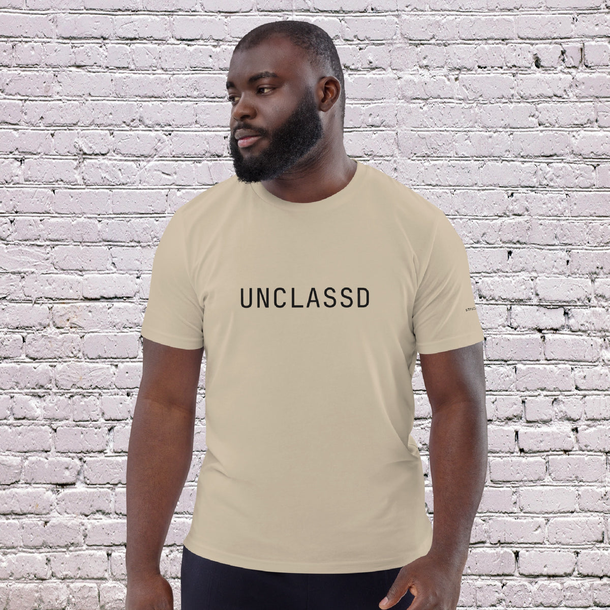 Male Model wearing UNCLASSD CORE Sand Tee during dance or rollerskate flow practice -front 