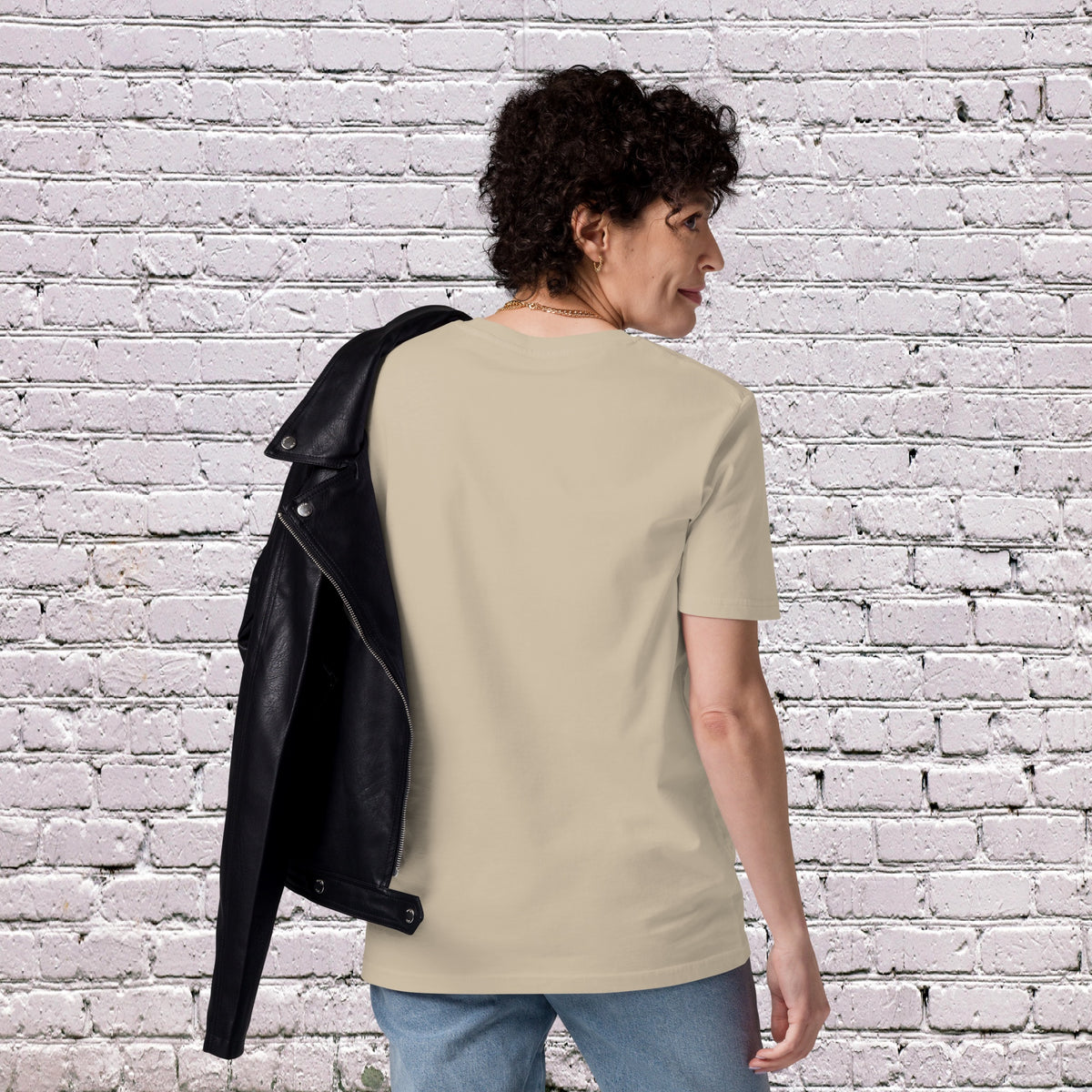 Female Model wearing UNCLASSD CORE Sand Tee during dance or rollerskate flow practice - back 