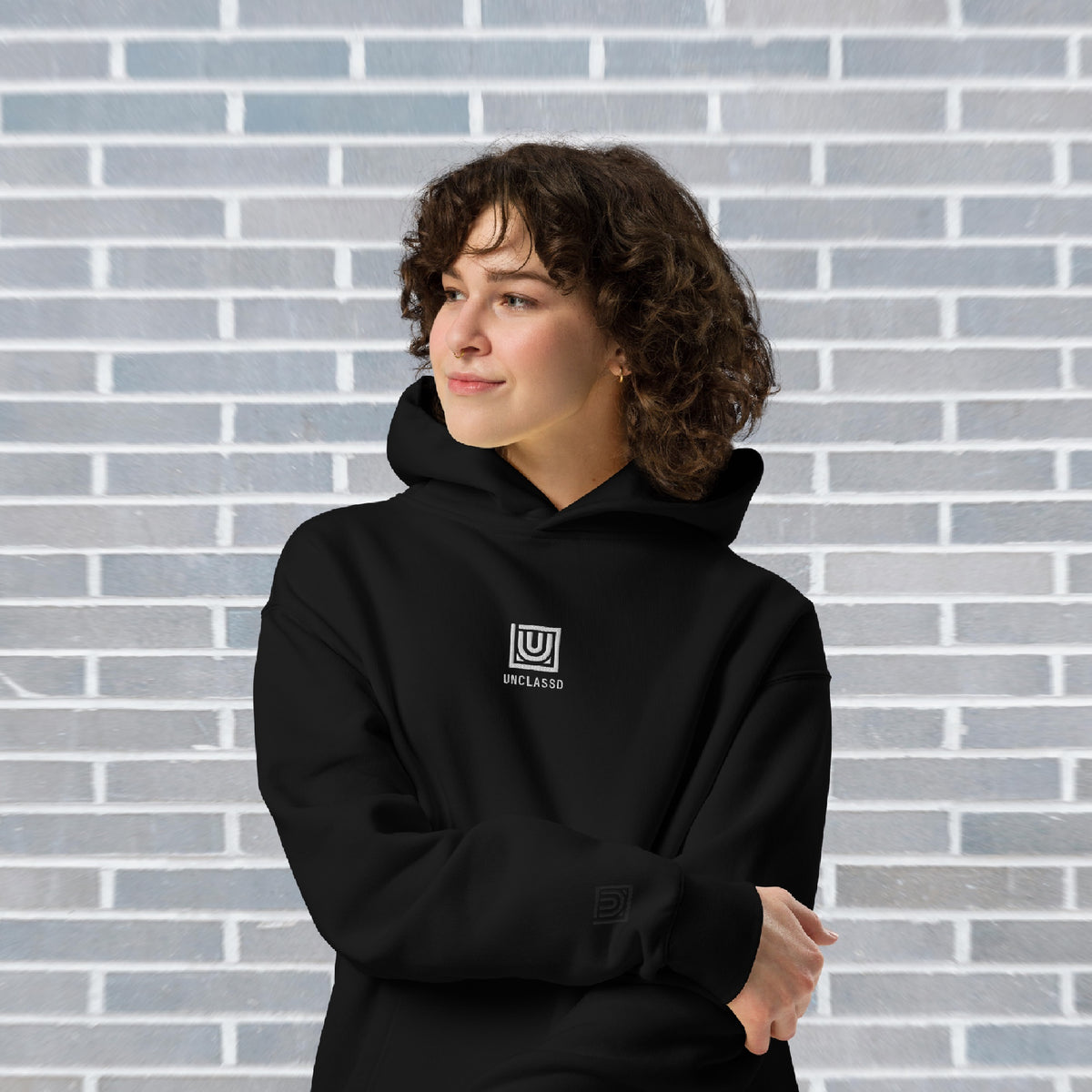 Female Dancer wearing UNCLASSD CORE oversized black hoodie for studio footwork and floorwork practices - front