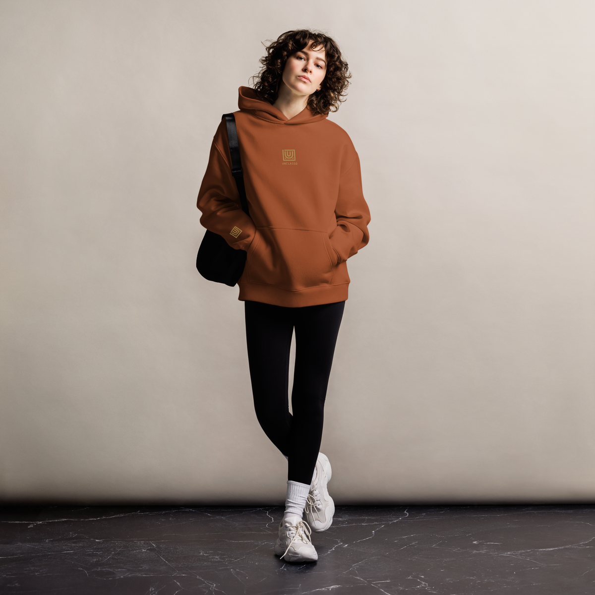 Women’s model wearing UNCLASSD Clay CORE Oversized Hoodie — dance & roller practice