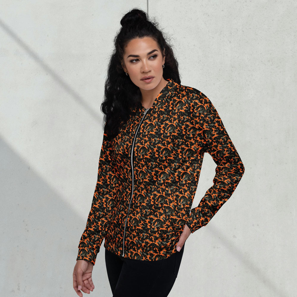 Model wearing a relaxed unisex orange camouflage fleece jacket with a streetwear outfit