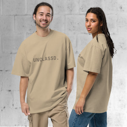 Models wearing the UNCLASSD CORE Oversized Tee in faded khaki. Side profile of the UNCLASSD CORE Oversized Tee, highlighting the structured drape and oversized silhouette.