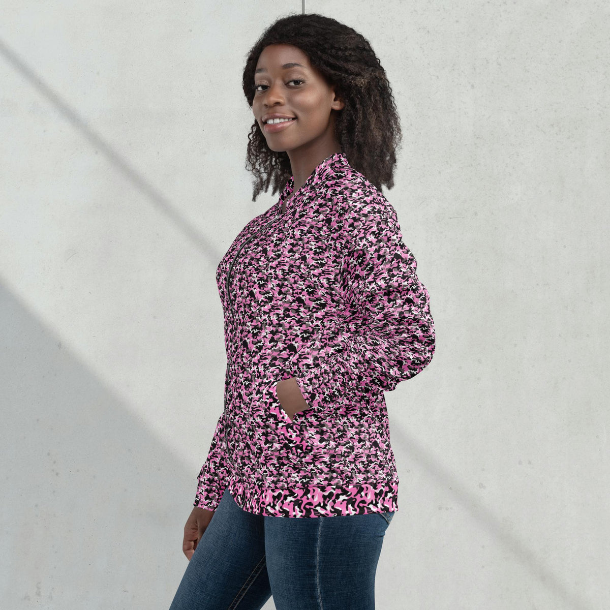 Model wearing a relaxed unisex pink camouflage fleece jacket with a streetwear outfit