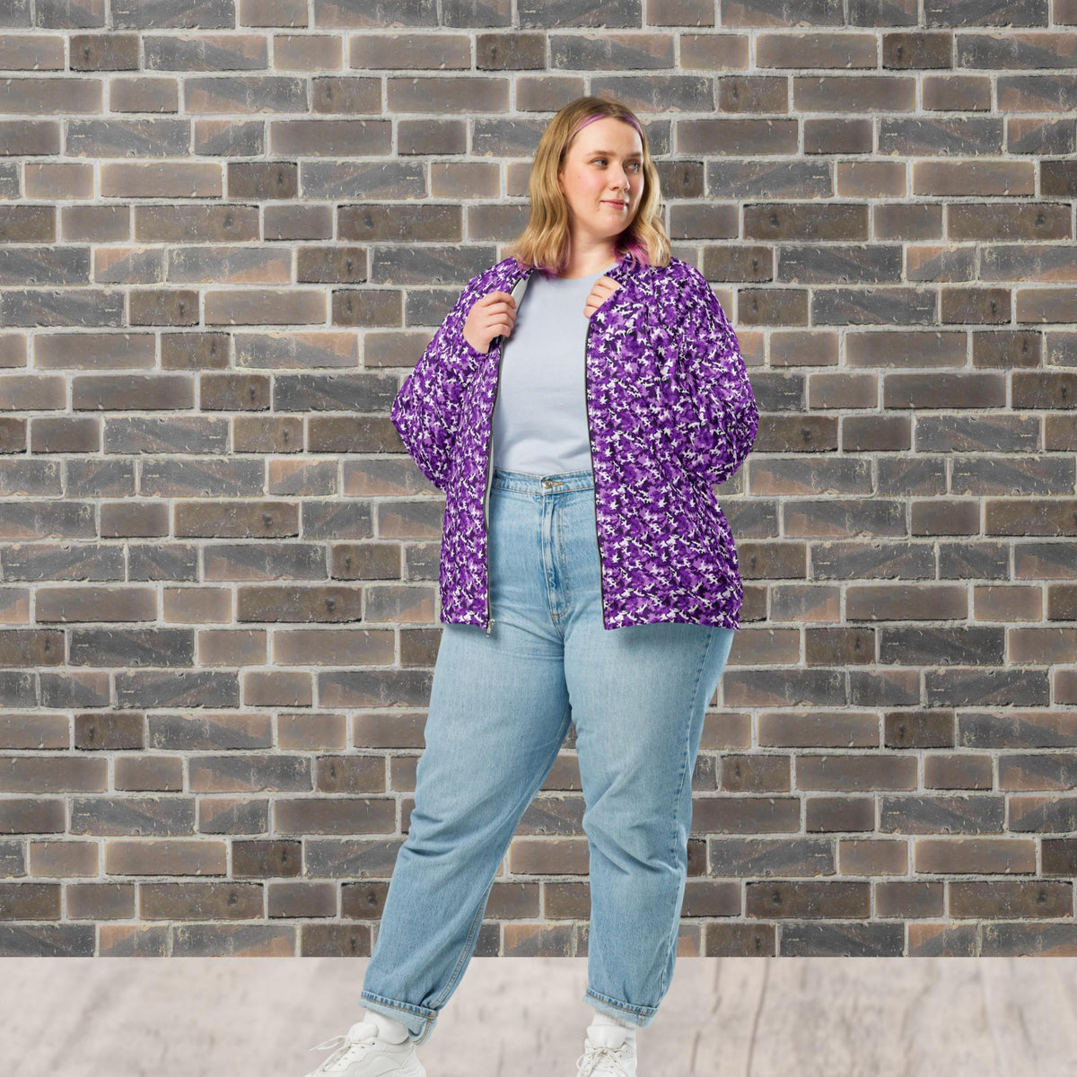 Model wearing a relaxed unisex purple camouflage fleece jacket with a streetwear outfit